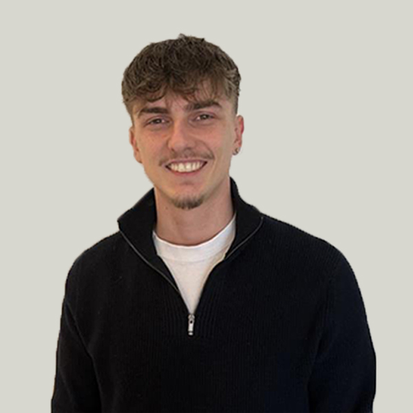 Alex, smiling friendly coach and co-founder of Open Play Development, dedicated to breaking down barriers in youth football